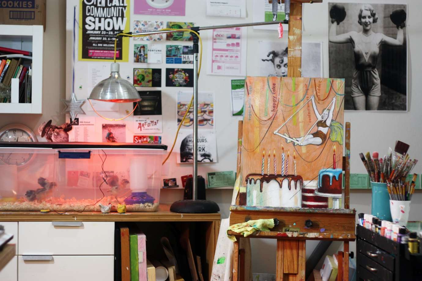 Stacy Crabill's studio seen with art on an easel and chicks in a brooder.