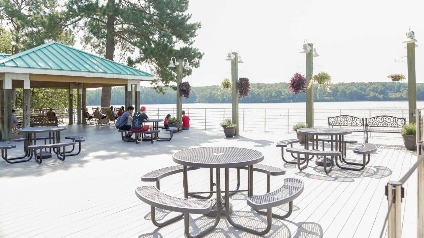 The outside deck with picnic tables overlooking the lake 