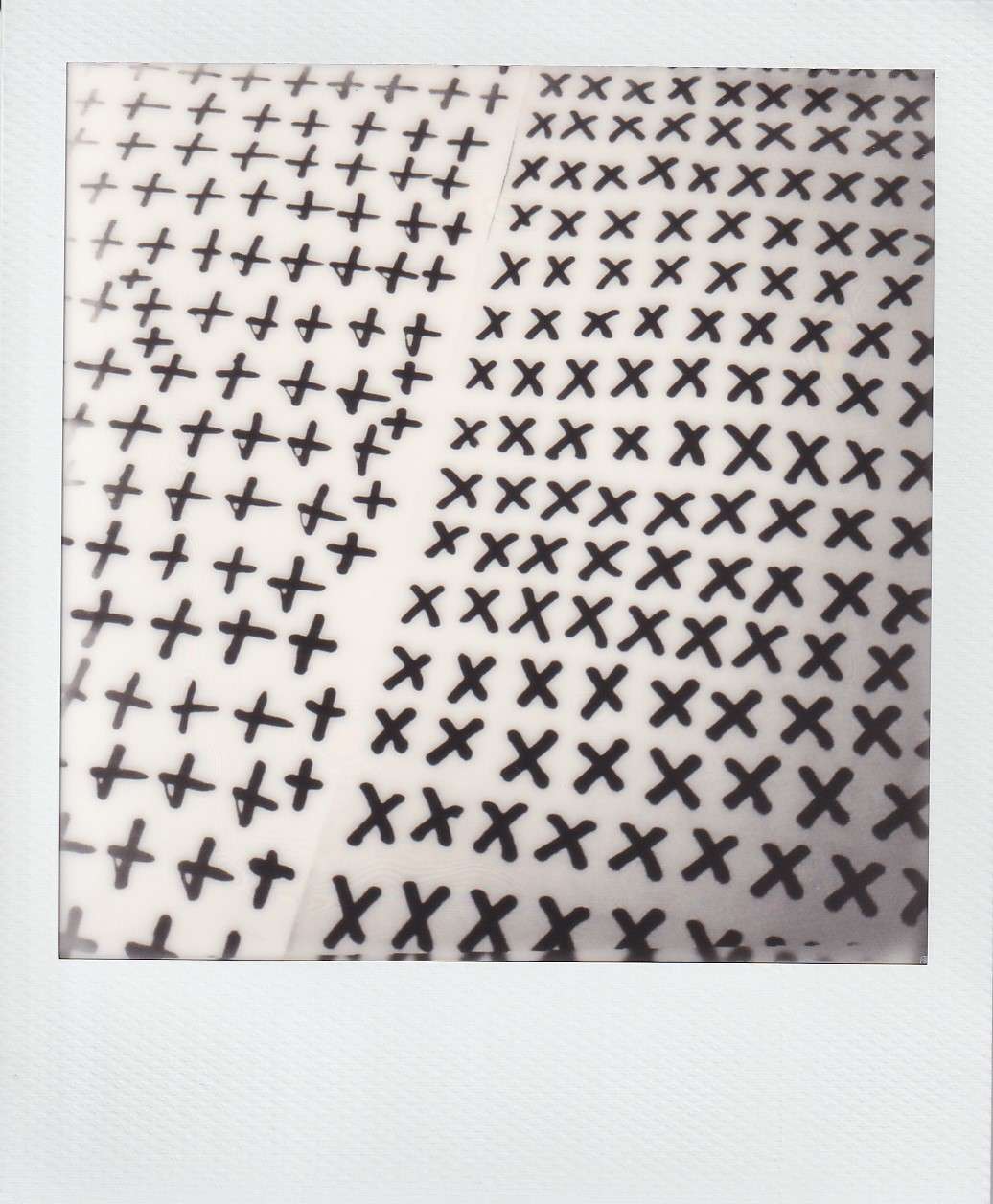 Polaroid photography by I'Nasah Crockett, plus signs and Xs drawn in rows using black marker