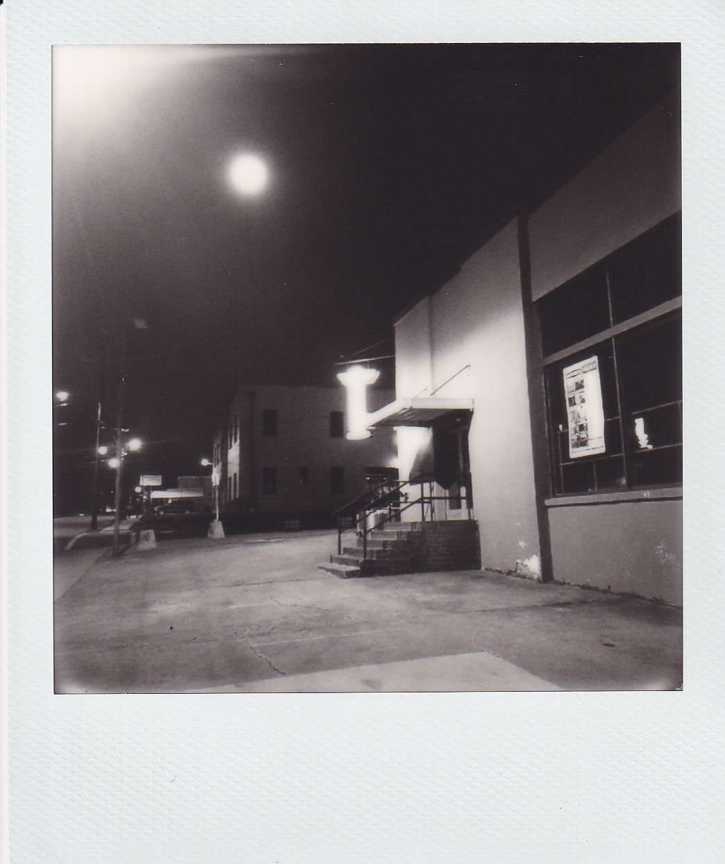 Polaroid photography by I'Nasah Crockette, steps and entrance on the side of city building at night