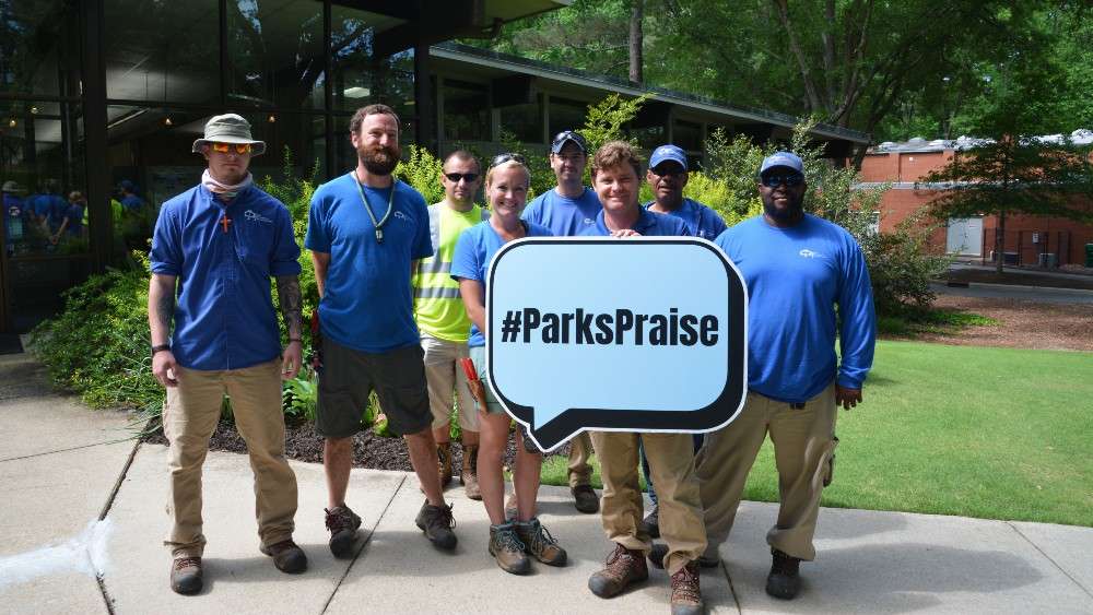 Group of parks staff holding Parks Praise sign