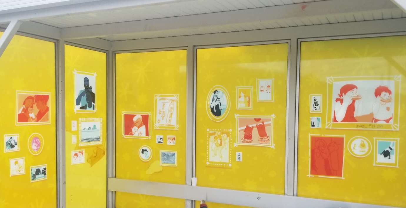 artwork by Anna Totten covering the windows of a bus shelter