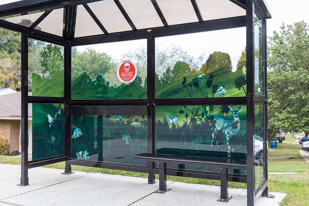 artwork by Annie Blazejack and Geddes Levenson covering the windows of a bus shelter