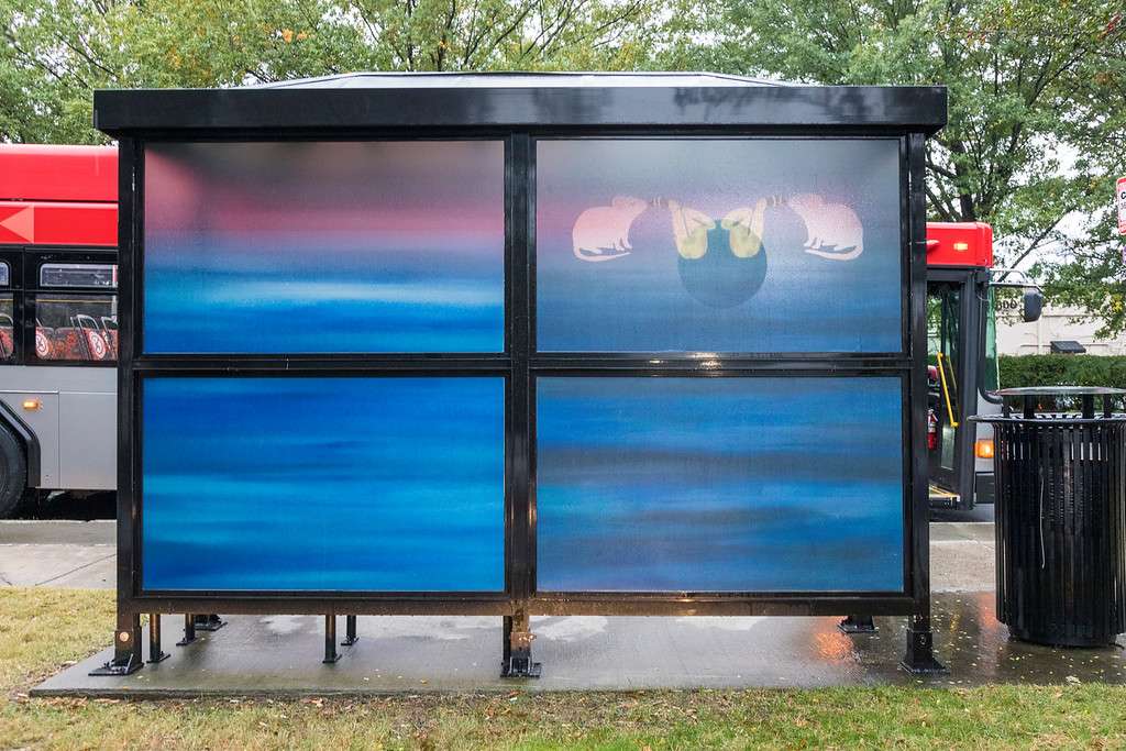 artwork by April Childers covering the windows of a bus shelter