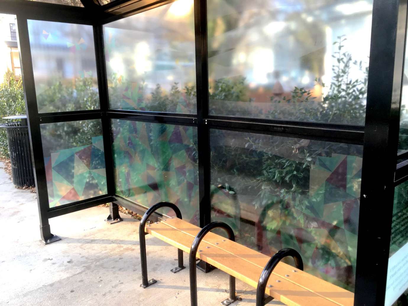 artwork by Fischer covering the windows of a bus shelter