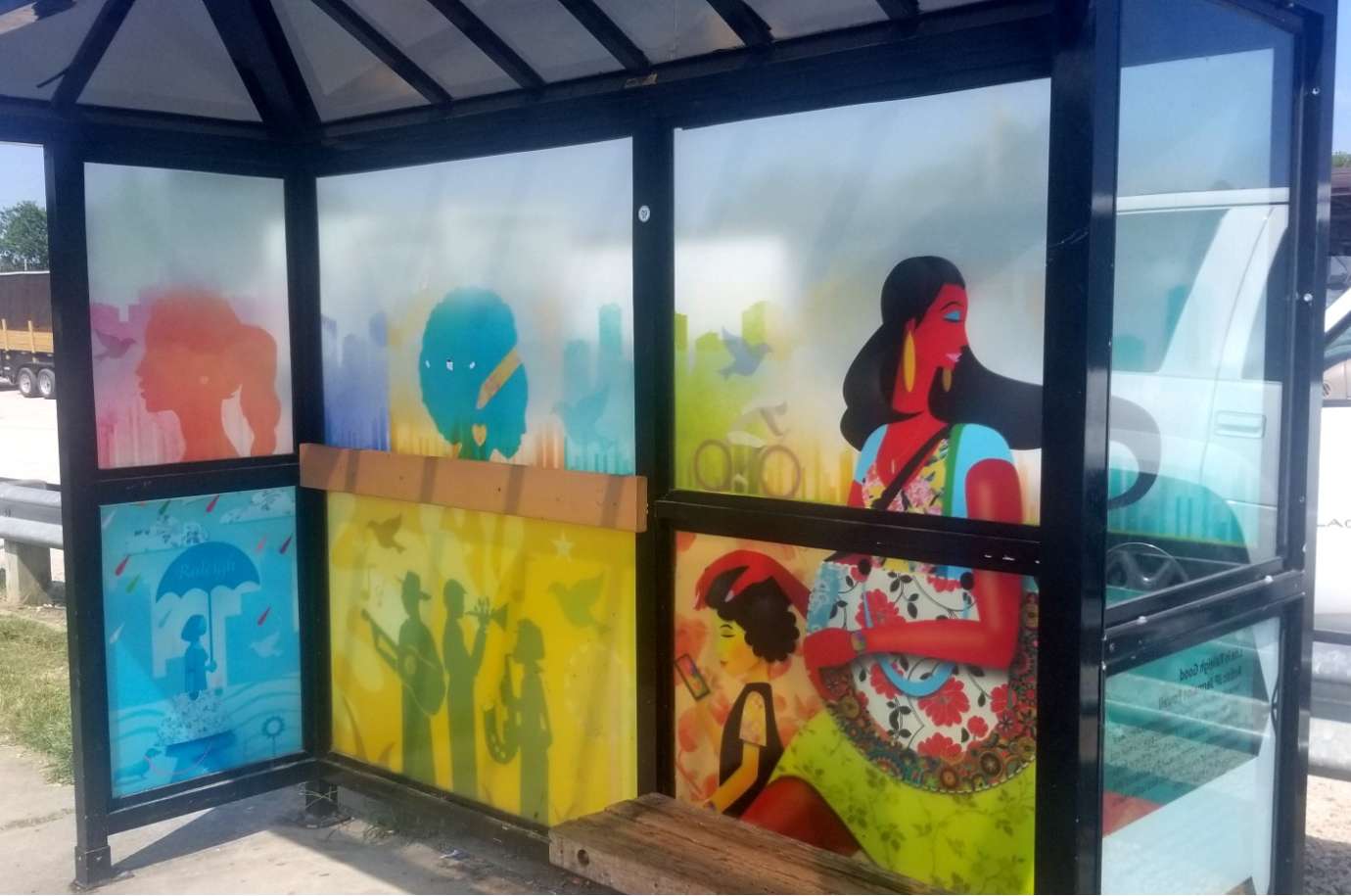 artwork by JP Jermaine Powell covering the windows of a bus shelter
