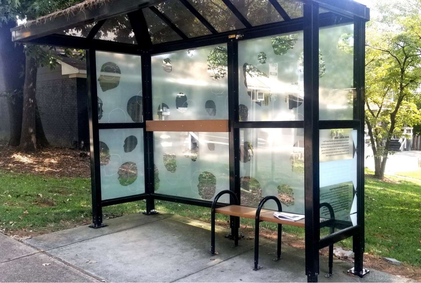 artwork by Jerstin Crosby covering the windows of a bus shelter