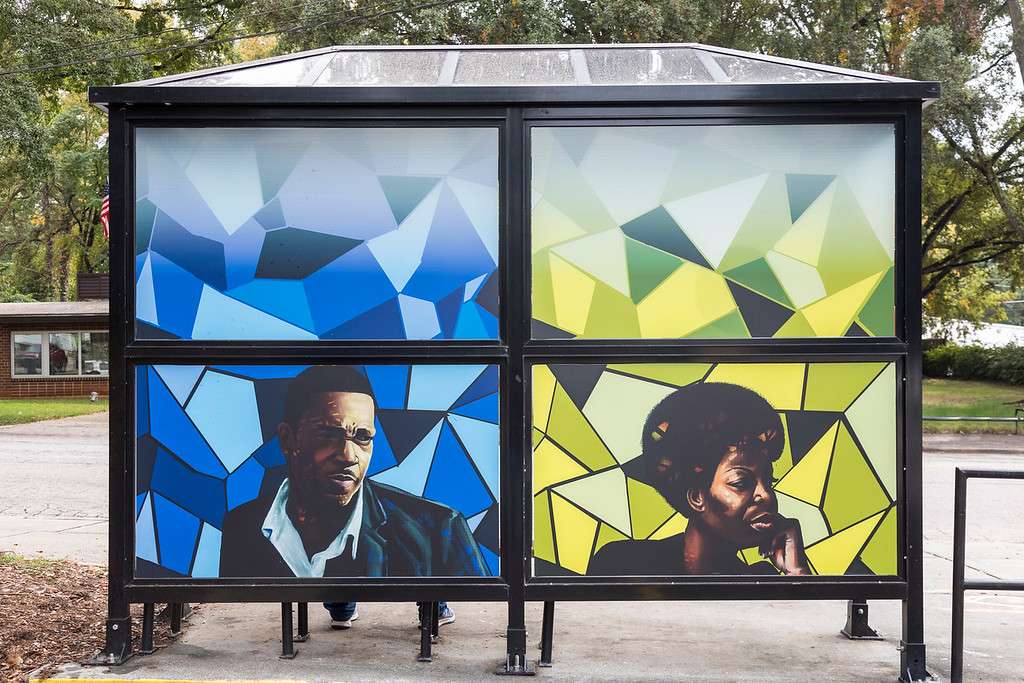 artwork by Kiara Sanders covering the windows of a bus shelter