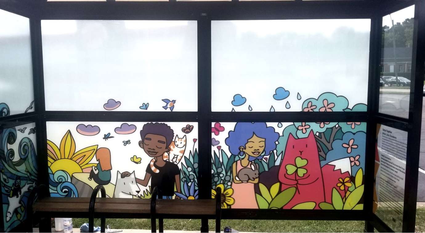 artwork by Lidia Churakova covering the windows of a bus shelter