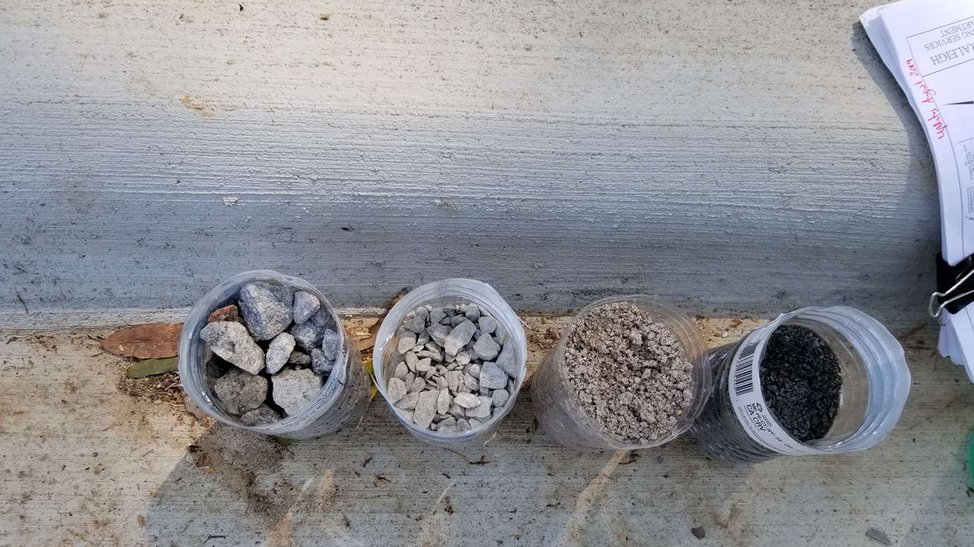 Samples of the stone, sand, and soil used in a bioretention area