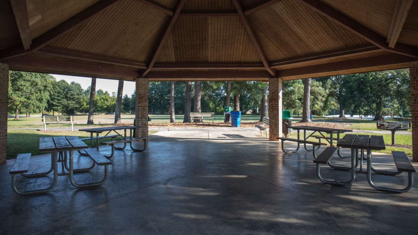 A closer look at the inside of the picnic shelter and the tables 