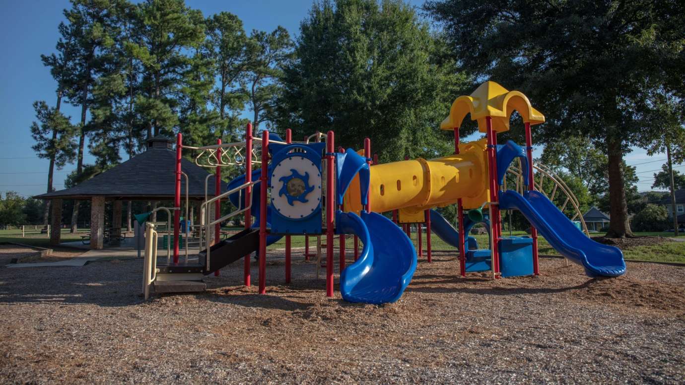 A large playground with two slides, climbing structures and more