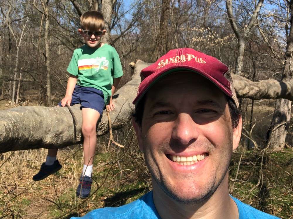 Selfie of Sam Hershey with kid in background
