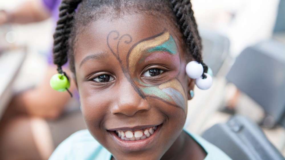 Little girl with butterfly painted on face