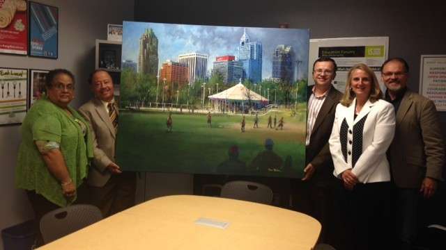 People smiling with painting of Chavis park