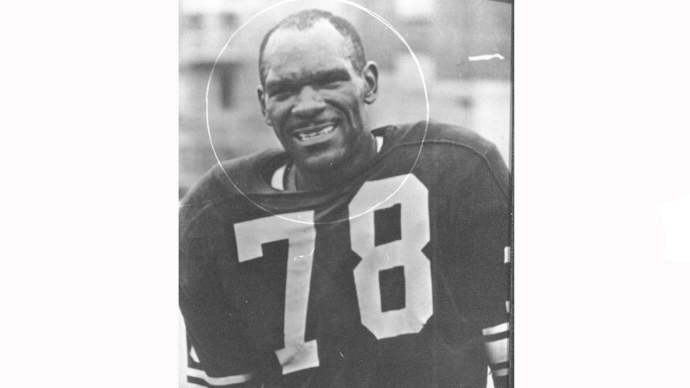 Black and white photo of man in football jersey that says 78