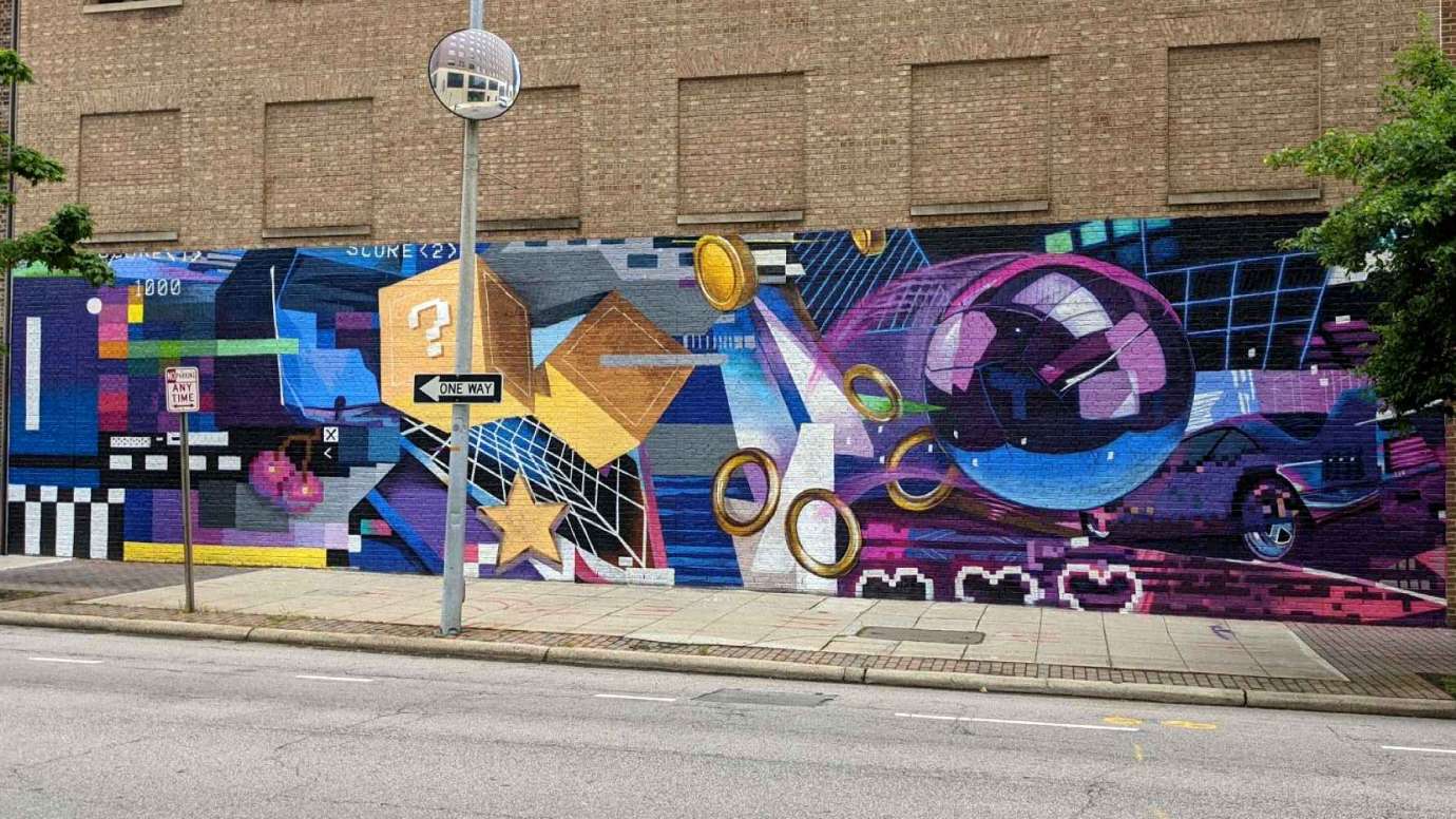 Mural by Taylor White that showcases the evolution of technology and gaming history titled 8 Bit to 5G