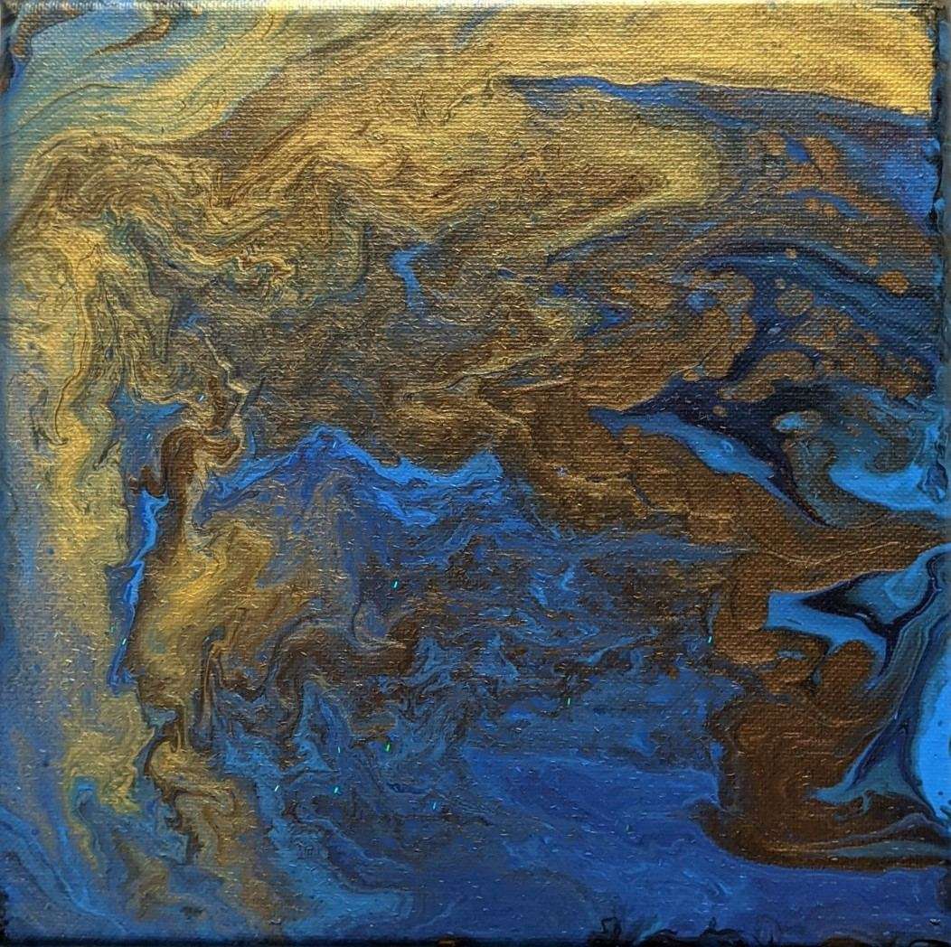 An abstract painting with golds and blues