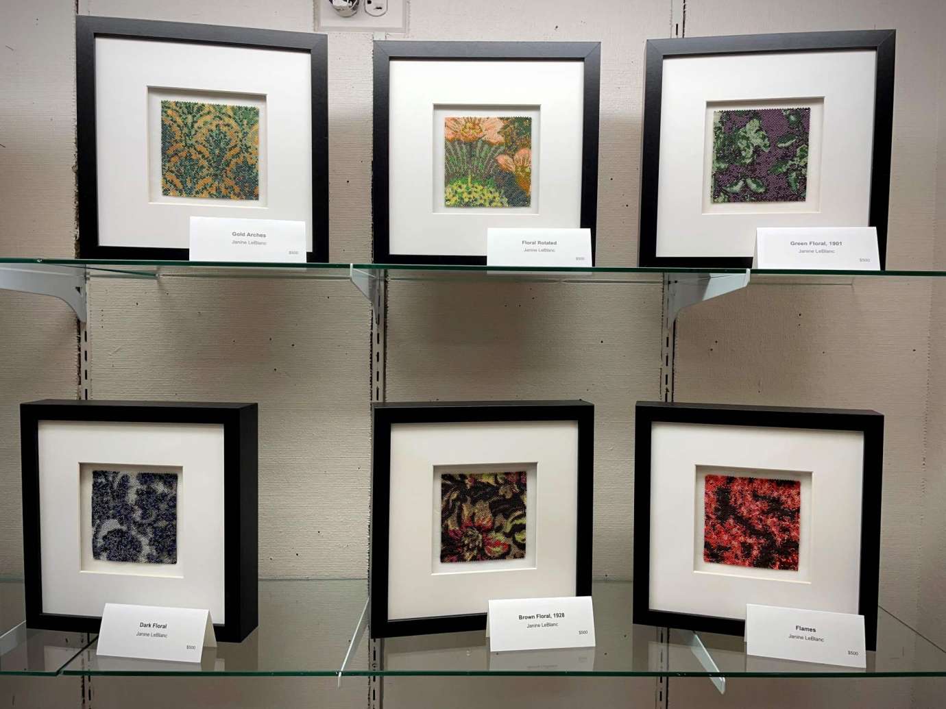 A case with class shelves display Janine LeBlanc's framed beadwork at Sertoma Arts Center