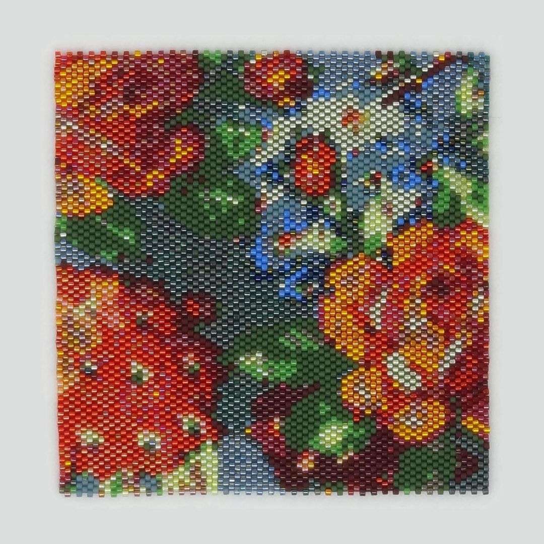 A close up of a floral pattern made from beads by artist Janine LeBlanc