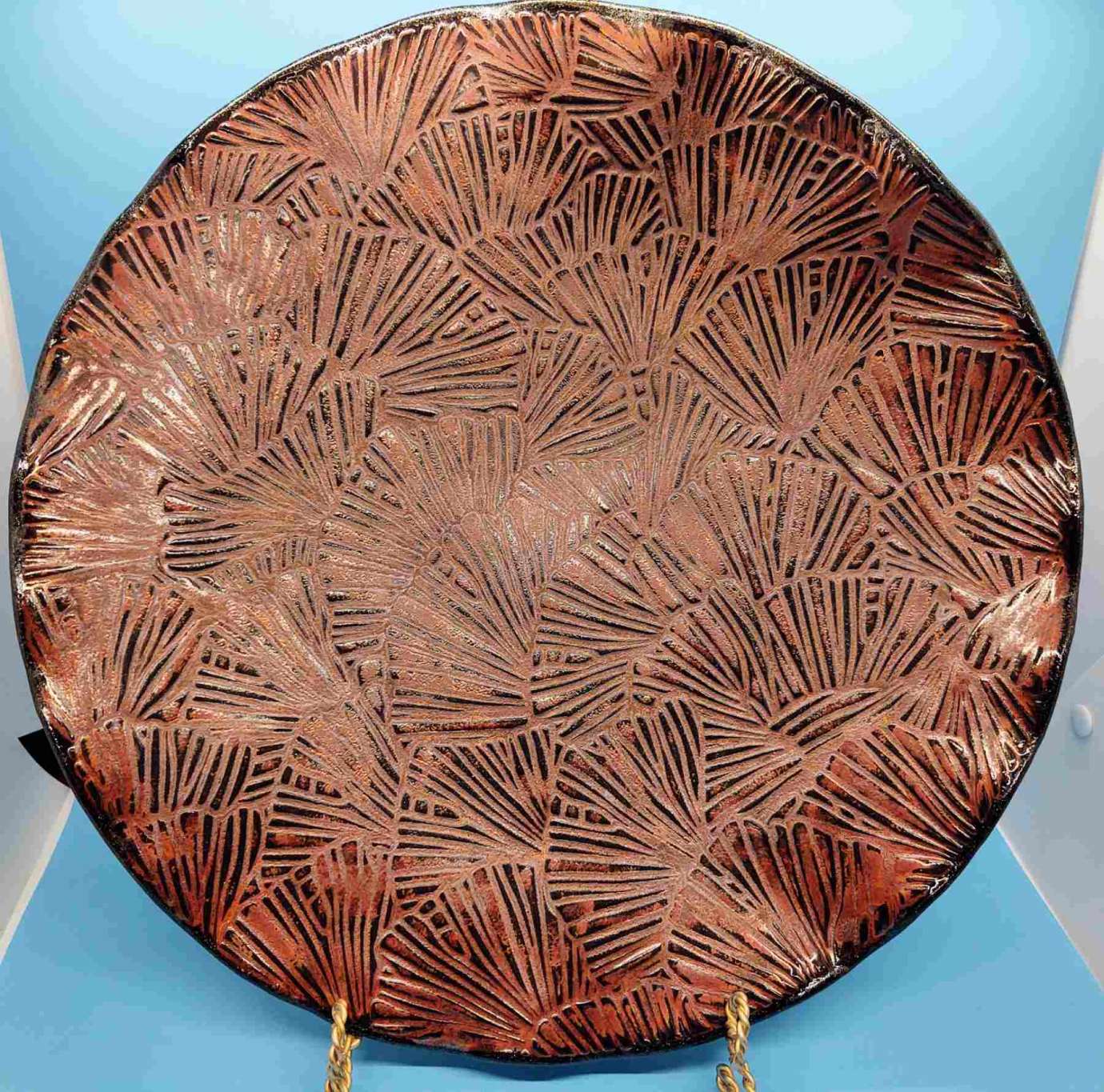 A rust colored ceramic patterned plate