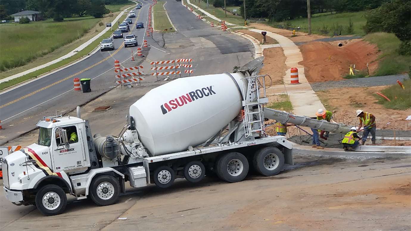 cement truck and a crew installing new sidewalk on Tryon Road