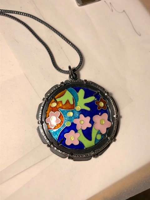 A necklace with a colorful flower pendant