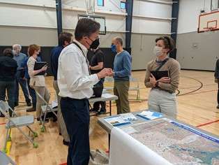 People talking at a stormwater public meeting 