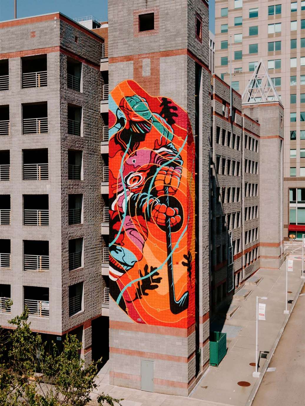 a large scale vibrant mural of Carolina Hurricanes player painted on a parking deck