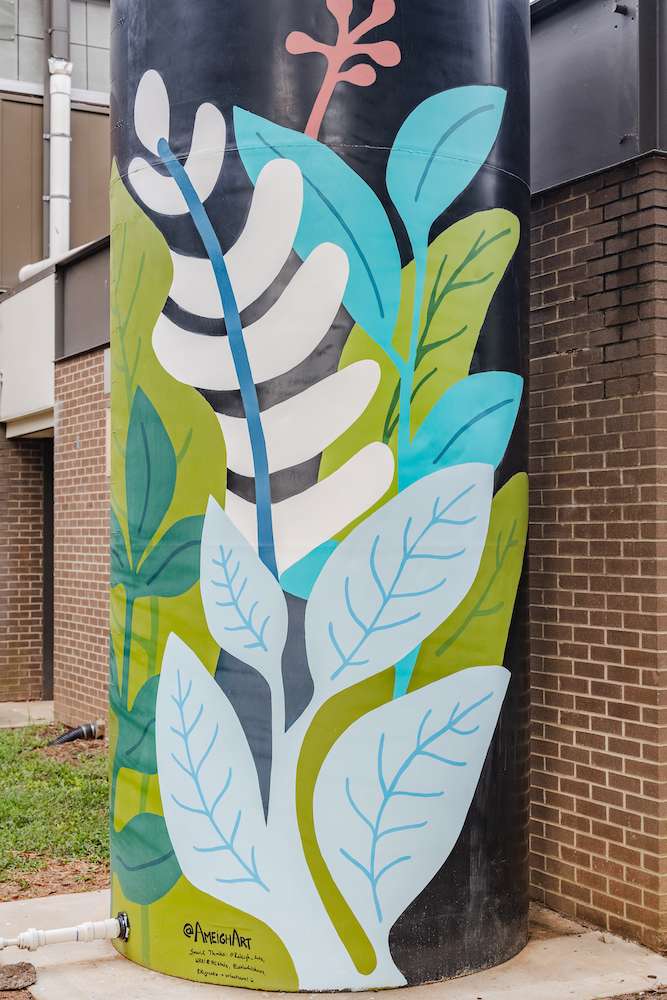 Vertical cistern painted with brightly colored plants