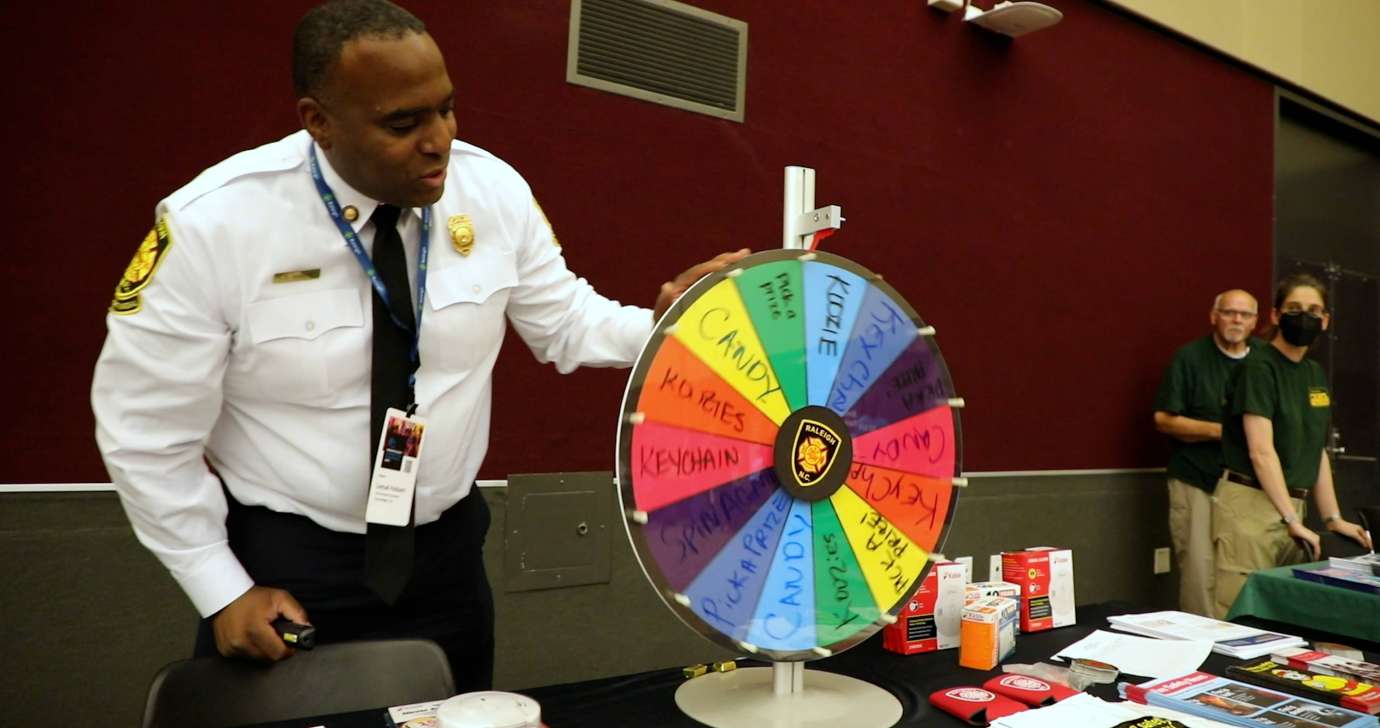 Table host spins a prize wheel at their table