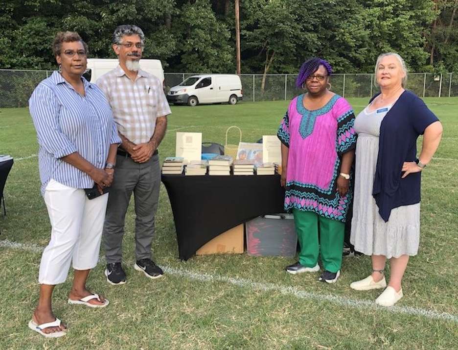 Human Relations Commission members posing for photo at book distribution event