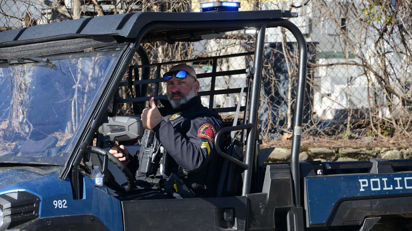 Police officer gives thumbs up in his all-terrain-vehicle