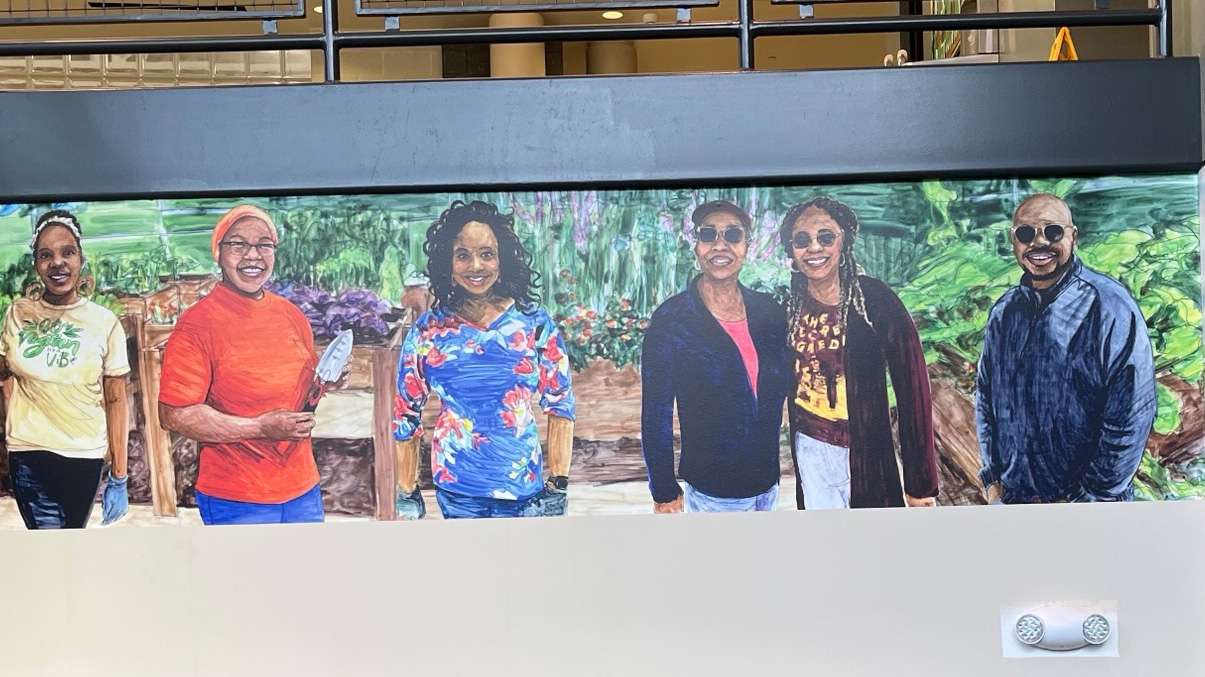 a painting of Barwell Road community members smiling