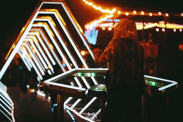 Person at the beginning of a geometric light tunnel