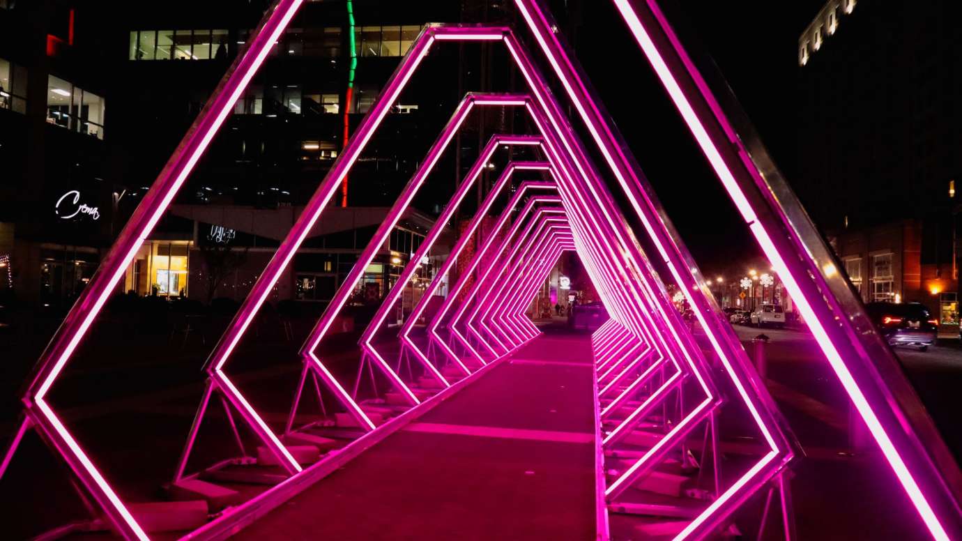 Geometric lights creating a pink tunnel. 