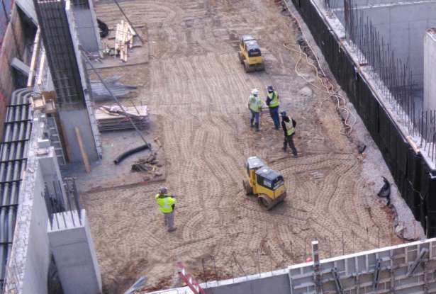 image shows construction site and trench roller being used 