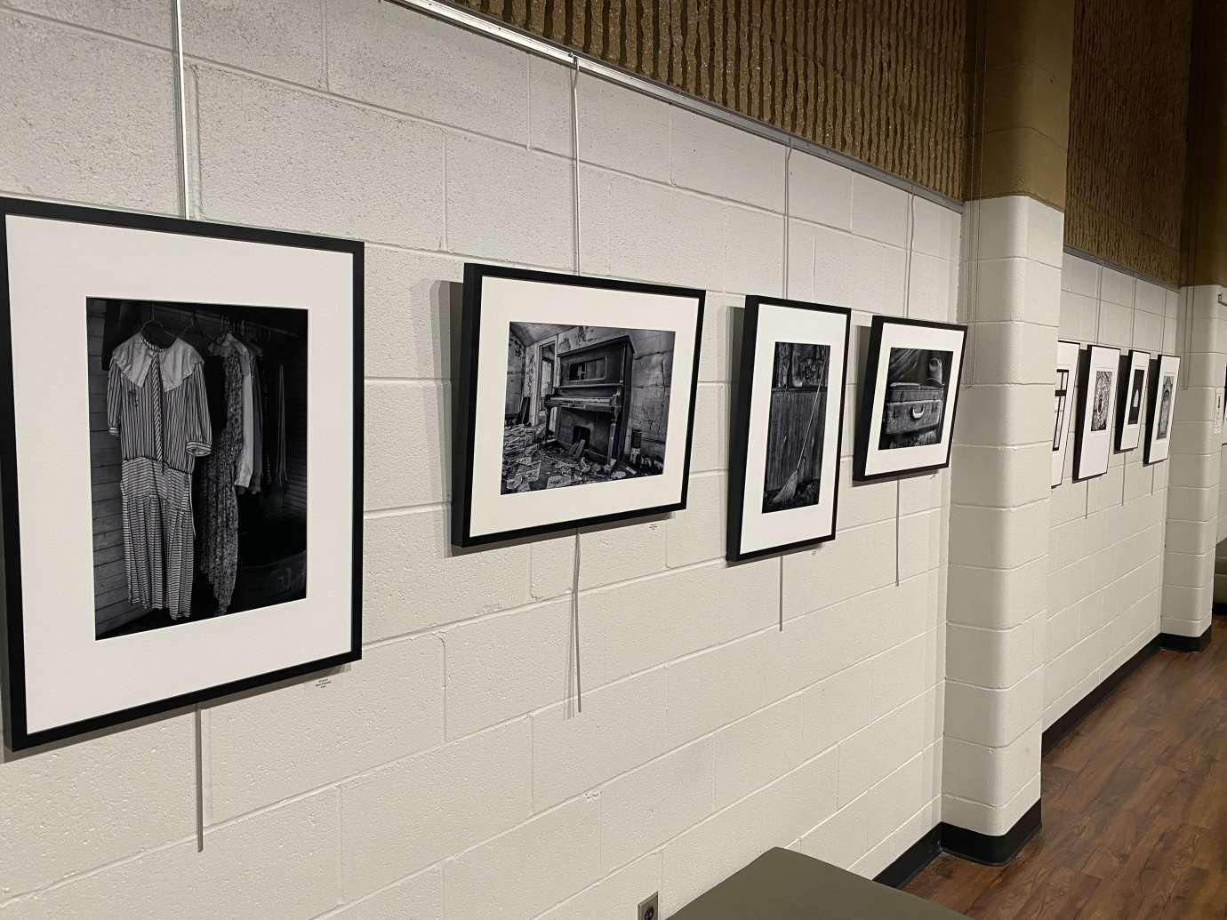 black and white photographs hanging on a white wall