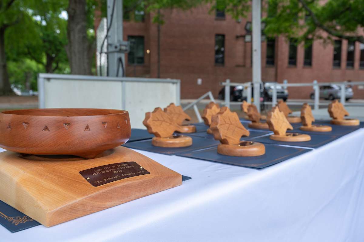 Environmental award winners accept a trophy. 