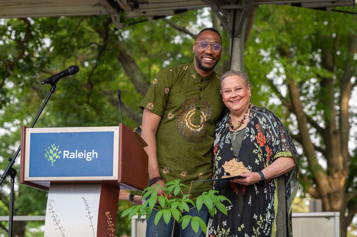Environmental award winners accept a trophy. 