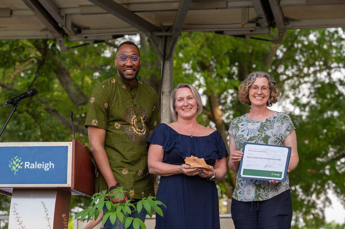 Environmental award winners accept a trophy. 