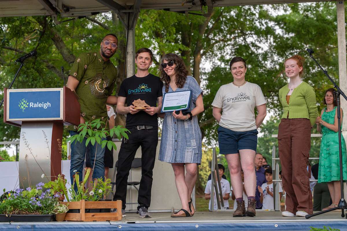 Environmental award winners accept a trophy. 