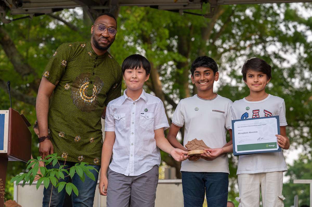 Environmental award winners accept a trophy. 
