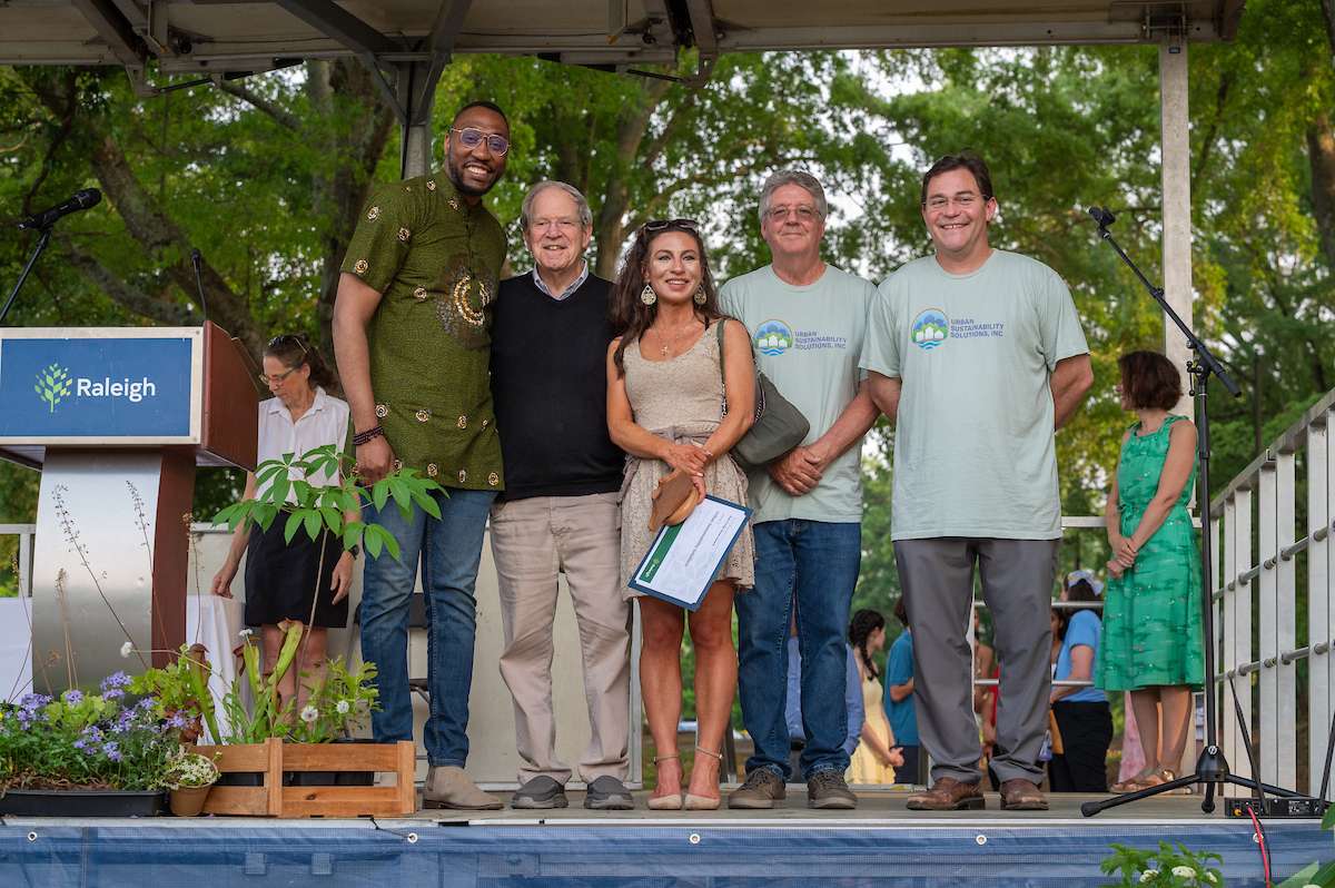 Environmental award winners accept a trophy. 