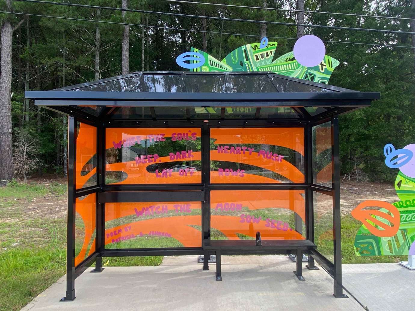 Artwork and poetry installed behind bus shelter