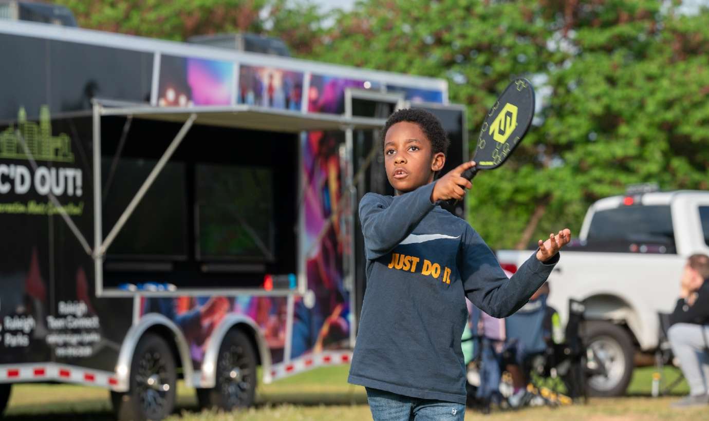 a kid playing a game outside