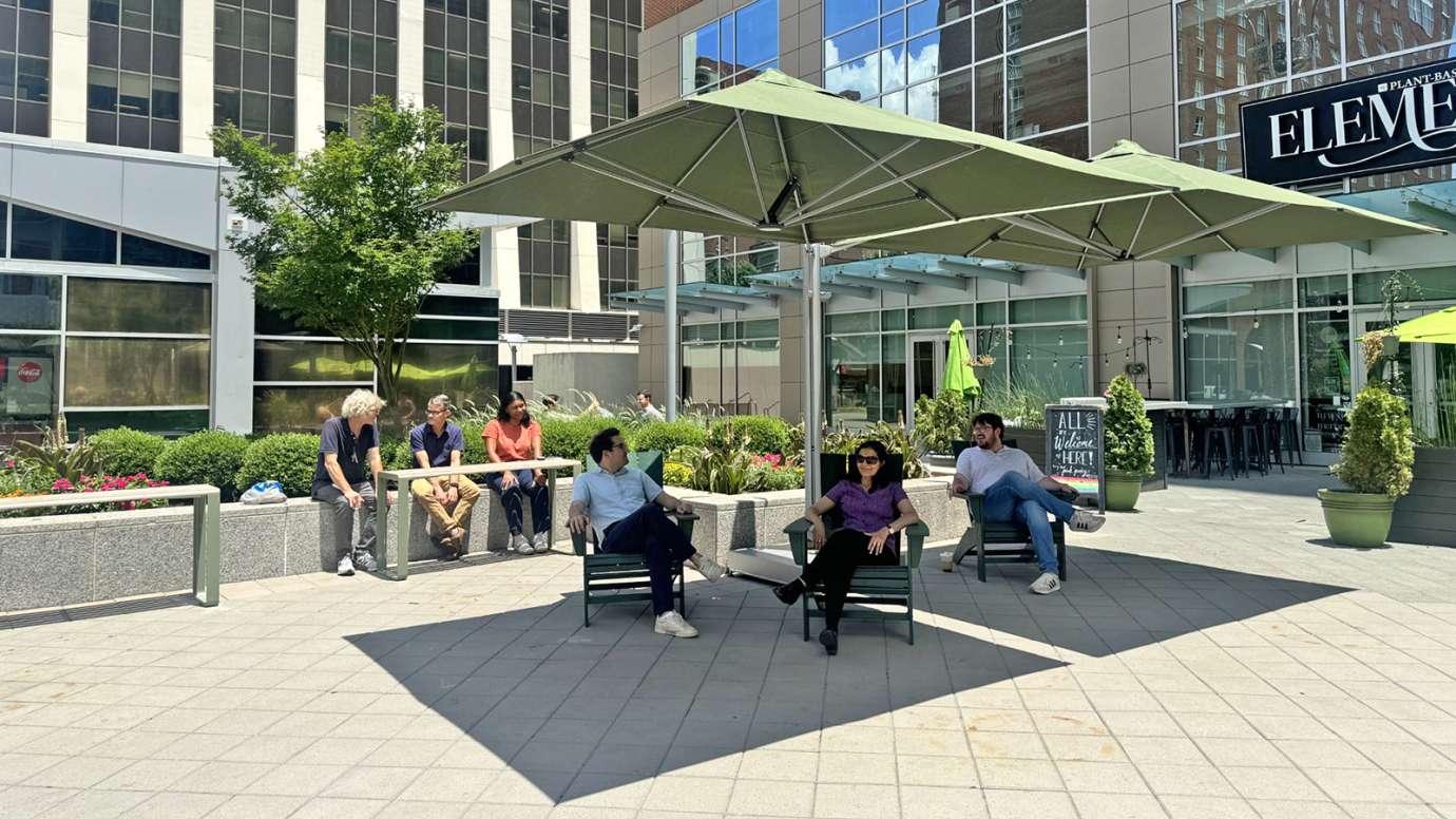 City Plaza Lounge Seating and Lookout Tables Under Shade Umbrellas