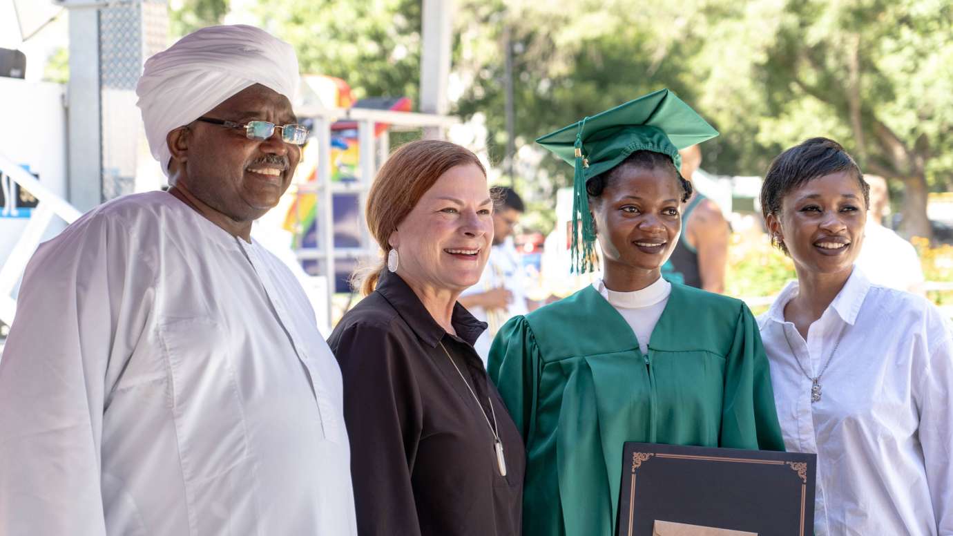 a famly posing for a graduation photo with a former mayor