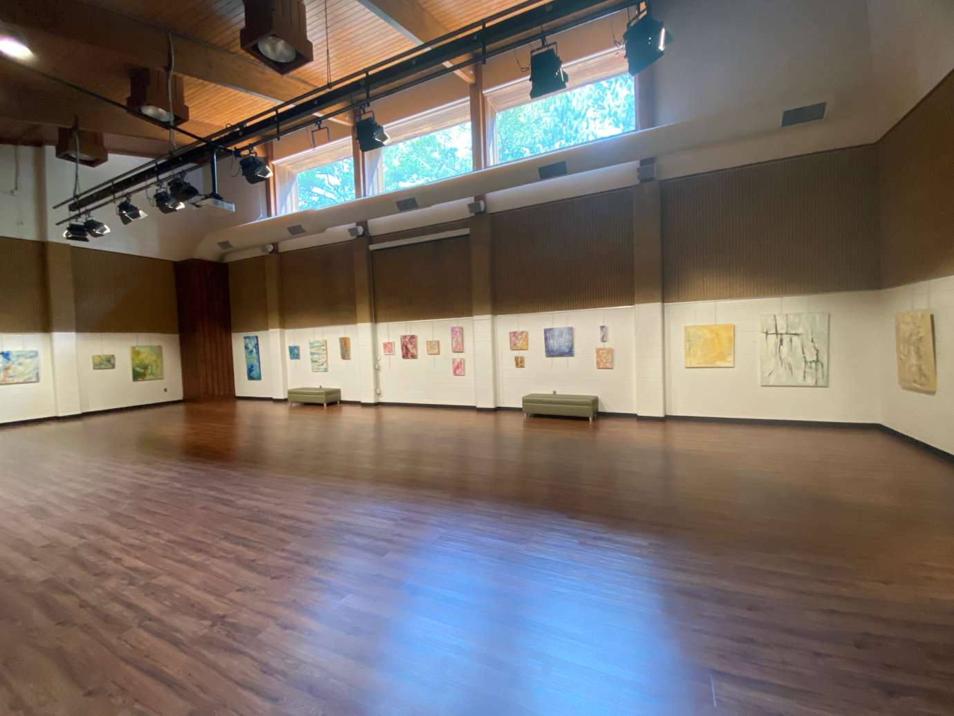Oil and Cold Wax Artworks hanging on a wall in a large room 