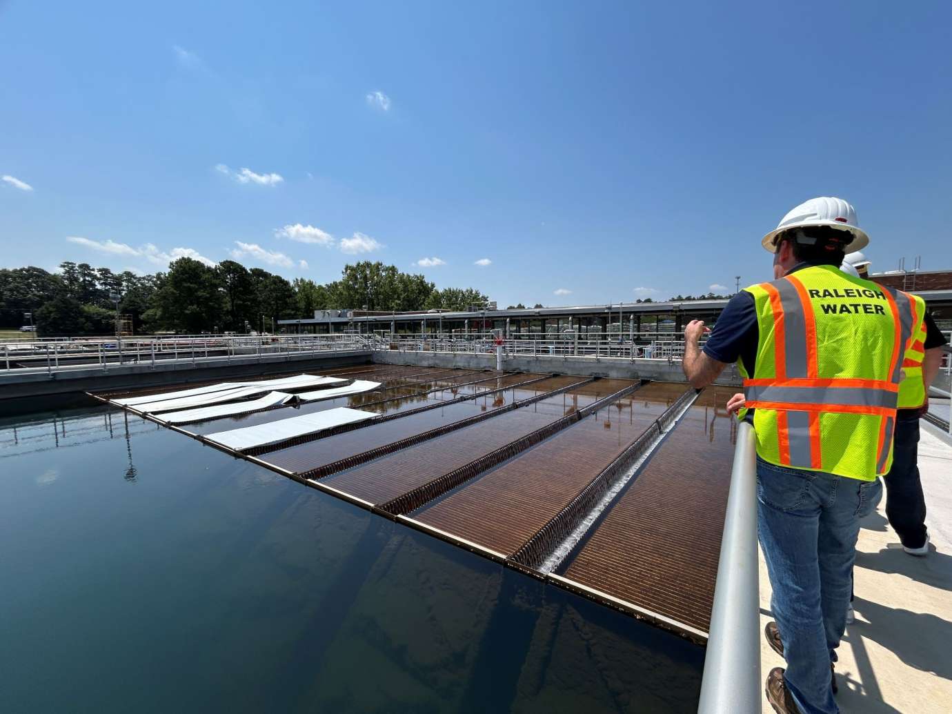 Worker speaking with others about water treatment process